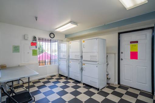 A room with a black and white checkered floor and white walls.