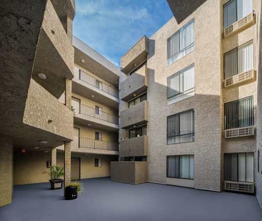 A courtyard of a building with a clear blue sky.