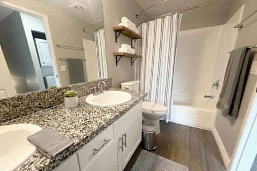A bathroom with a sink, toilet, and bathtub.