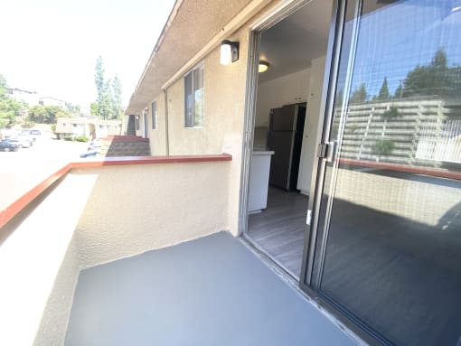 a view of the front porch of a building with a glass door