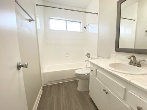 an empty bathroom with a sink toilet and shower