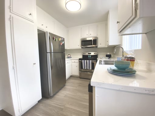 a kitchen with stainless steel appliances and white cabinets
