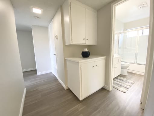 a renovated bathroom with a white cabinet and a toilet