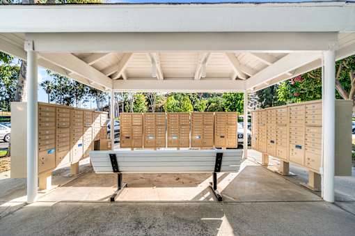 A white covered walkway with a bench in the middle.