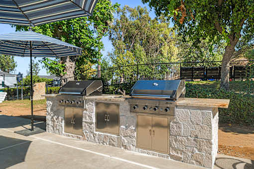A stone wall with two grills on top.