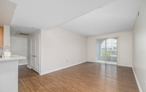 A room with wooden floors and white walls.