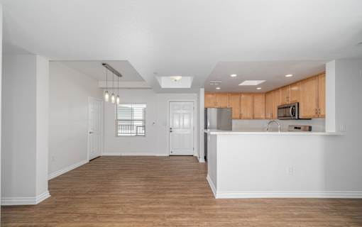 A kitchen with wooden cabinets and a white countertop.