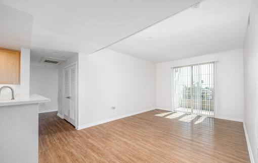 A room with wooden floors and white walls.