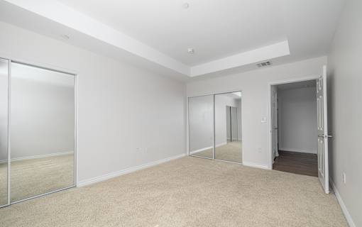 A room with white walls and a carpeted floor.