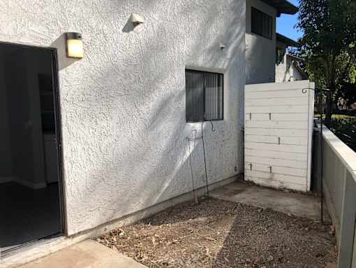 A white house with a small window and a door.