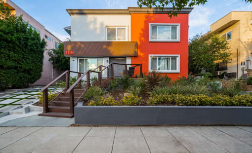 the front of a house with a garden in front of it