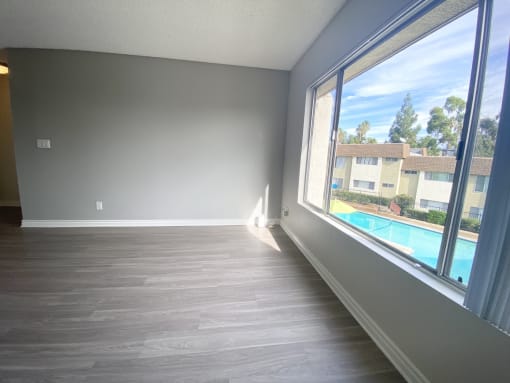 an empty living room with a large window