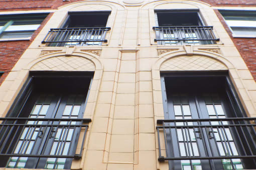 the facade of a building with windows and a balcony