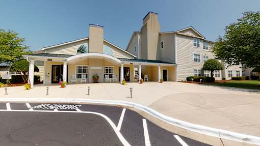 A large building with a parking lot in front of it.