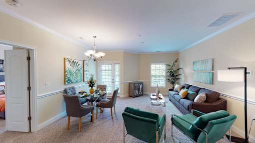 A living room with a dining table and chairs.