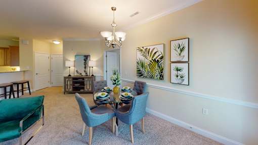 A dining room with a table set for four.
