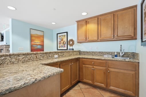 a kitchen with granite countertops and wooden cabinets