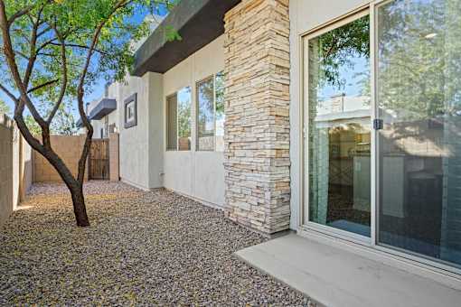 A house with a tree in front of it.