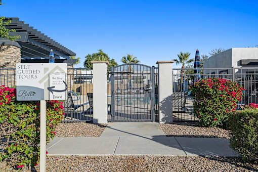The gate of a self-guided tours sign is open.