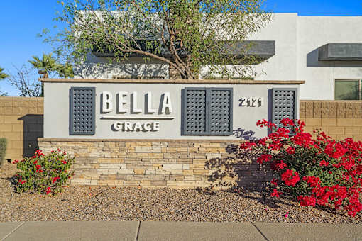 A sign that says Bella Grace in front of a building.