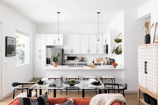A modern kitchen with a dining table and chairs.