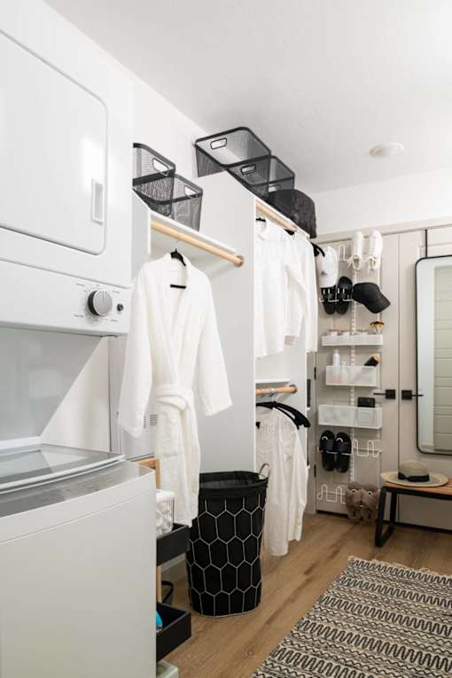 A white oven and towel rack in a small room.