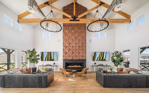 A modern living room with a fireplace and a large screen TV.