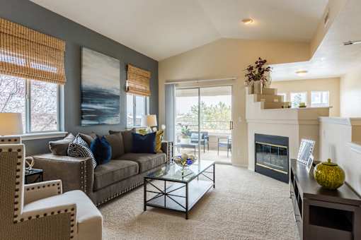 Living area with windows, fireplace, and sliding glass doors to patio at Bridgwater, Greenwood Village, CO
