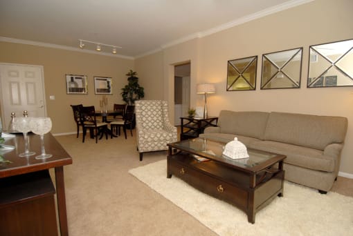 Livingroom with furniture, a rug and decor on the walls.