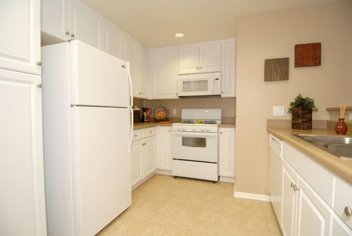 Kitchen with white cabinets and appliances