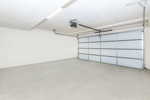 an empty garage with a white wall and a white garage door