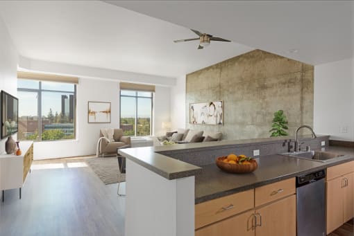 Kitchen overlooking living room with large windows at Vendome Place, California