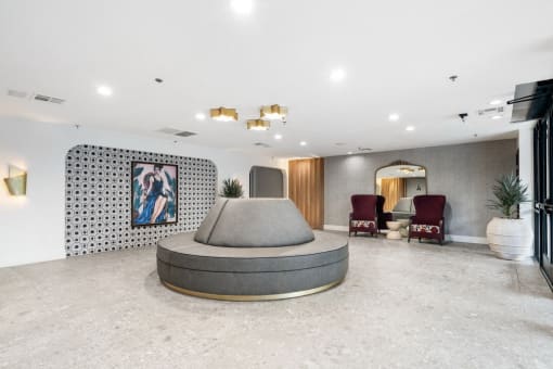 a lobby with a round couch and seating at Vera Cortez Hill, San Diego, 92101