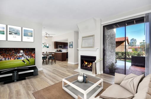 Living area with fireplace, TV, and sliding glass doors to balcony at Pointe Niguel, Laguna Niguel, California