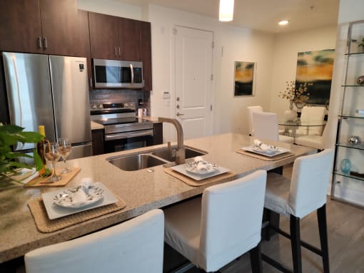 Phoenix, AZ Luxury Apartments For Rent - Level At Sixteenth - Kitchen With Island, Wooden Cabinets, And Stainless-Steel Appliances