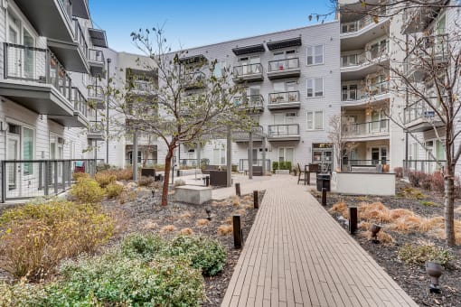 Building Surrounded By Lush Landscaping with View of Outdoor Lounge at Waterford RiNo, Denver, CO