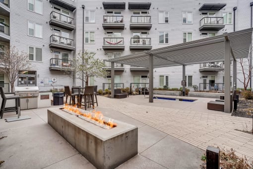 Firepit And Grill Area Near The Spa With Tables And Chairs at Waterford RiNo, Denver, 80216