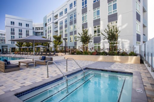 a swimming pool with a building in the background