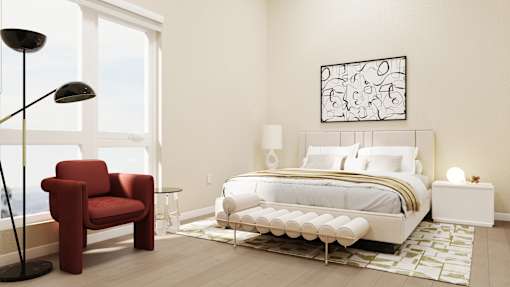 A red chair sits next to a bed in a white bedroom at Skyview Sunset Apartments, California