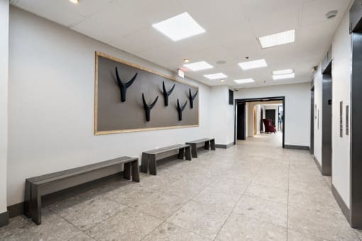 Hallway with bench seating and elevators at Vera Cortez Hill, San Diego, CA