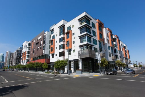 Luxury Apartments in San Francisco CA-Venue Apartments Street Corner View Of Exterior Of Complex Lined With Trees