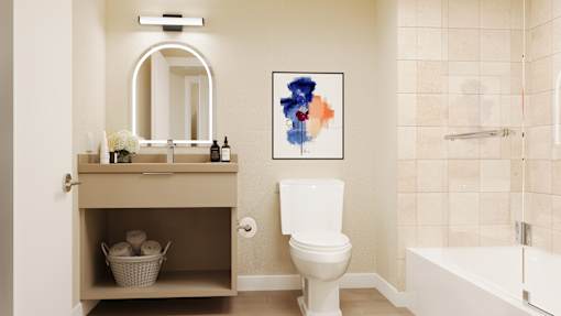 A bathroom with a toilet, sink, and tub at Skyview Sunset Apartments, Los Angeles, California