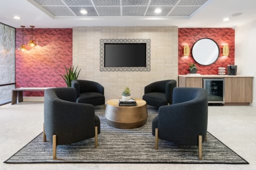 Clubroom with chairs, table and a television at Vera Cortez Hill, San Diego