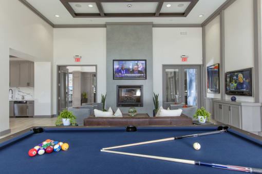 Clubroom with seating area and fireplace at The Grove Apartments, California