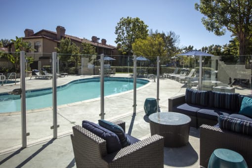 Seating area adjacent to pool with glass partition fence at Pointe Niguel, Laguna Niguel, 92677