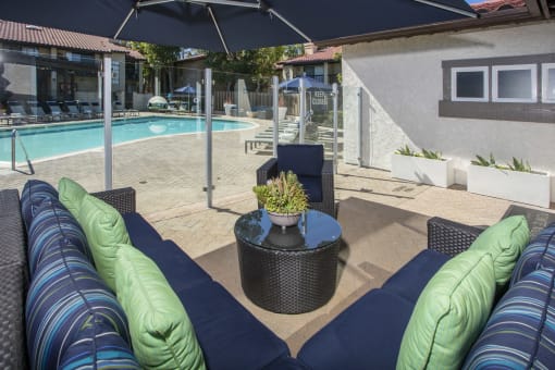 Seating area adjacent to pool with glass partition fence at Pointe Niguel, Laguna Niguel, CA