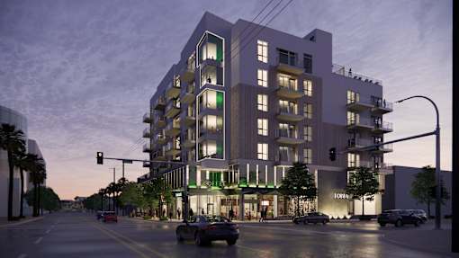 A modern apartment building with a street view in front at Skyview Sunset Apartments, California