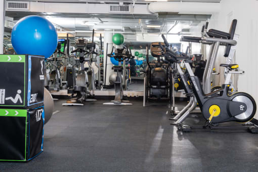 a gym with a lot of exercise machines and weights