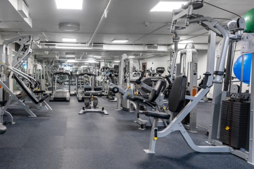 a gym full of exercise equipment in a building