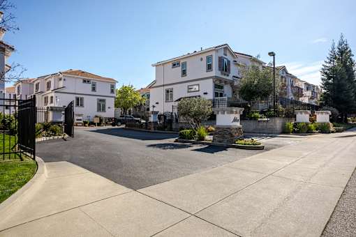 A street view of a residential area with houses on both sides.